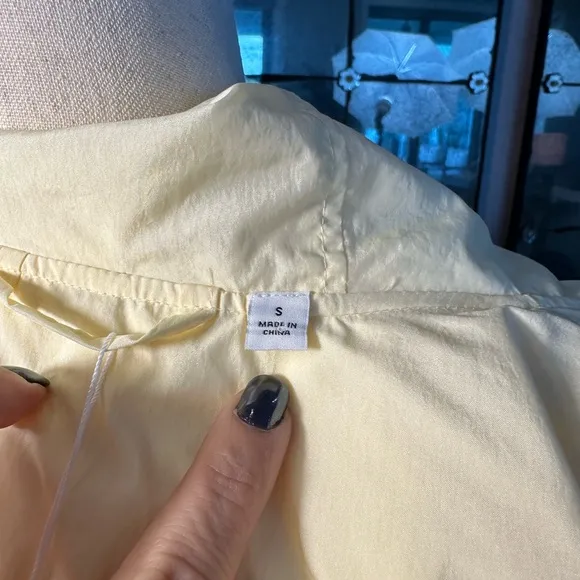 Uniqlo U packable yellow over sized hooded rain poncho.