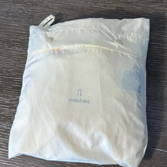 Uniqlo U packable yellow over sized hooded rain poncho.