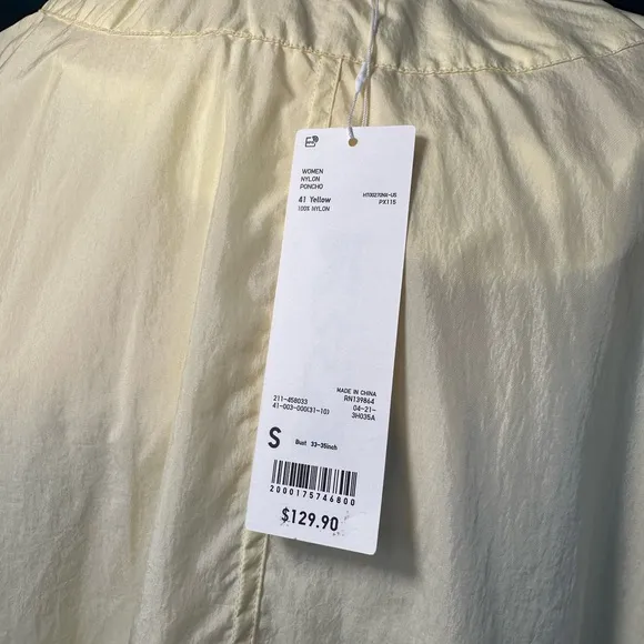 Uniqlo U packable yellow over sized hooded rain poncho.