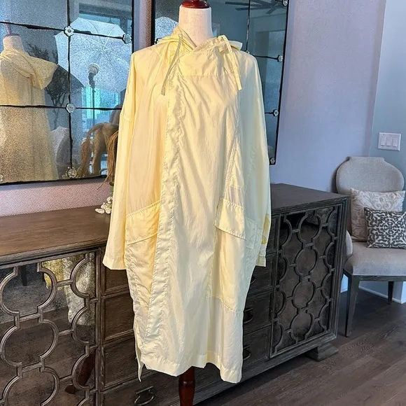 Uniqlo U packable yellow over sized hooded rain poncho.