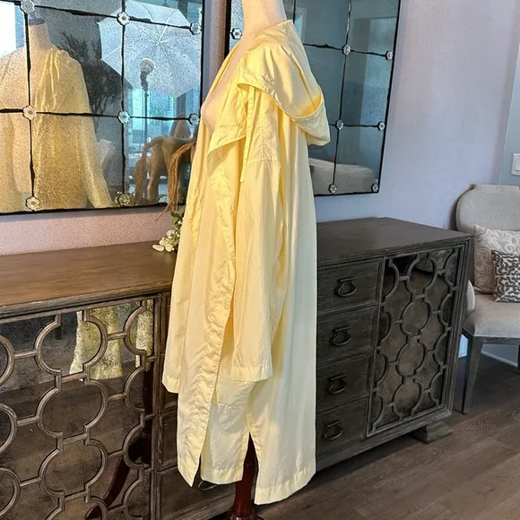 Uniqlo U packable yellow over sized hooded rain poncho.