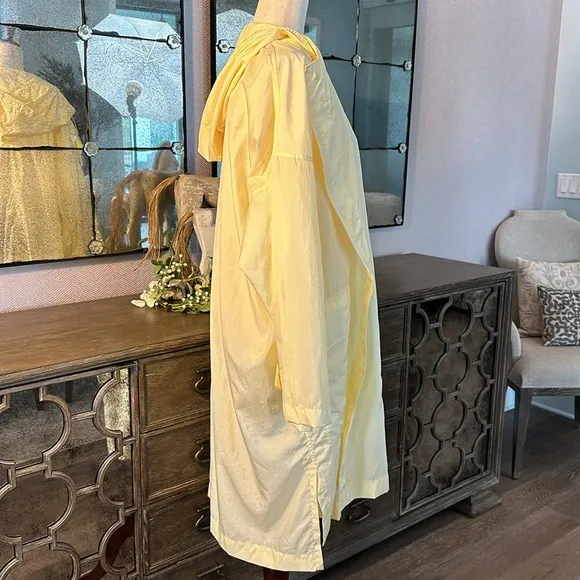 Uniqlo U packable yellow over sized hooded rain poncho.